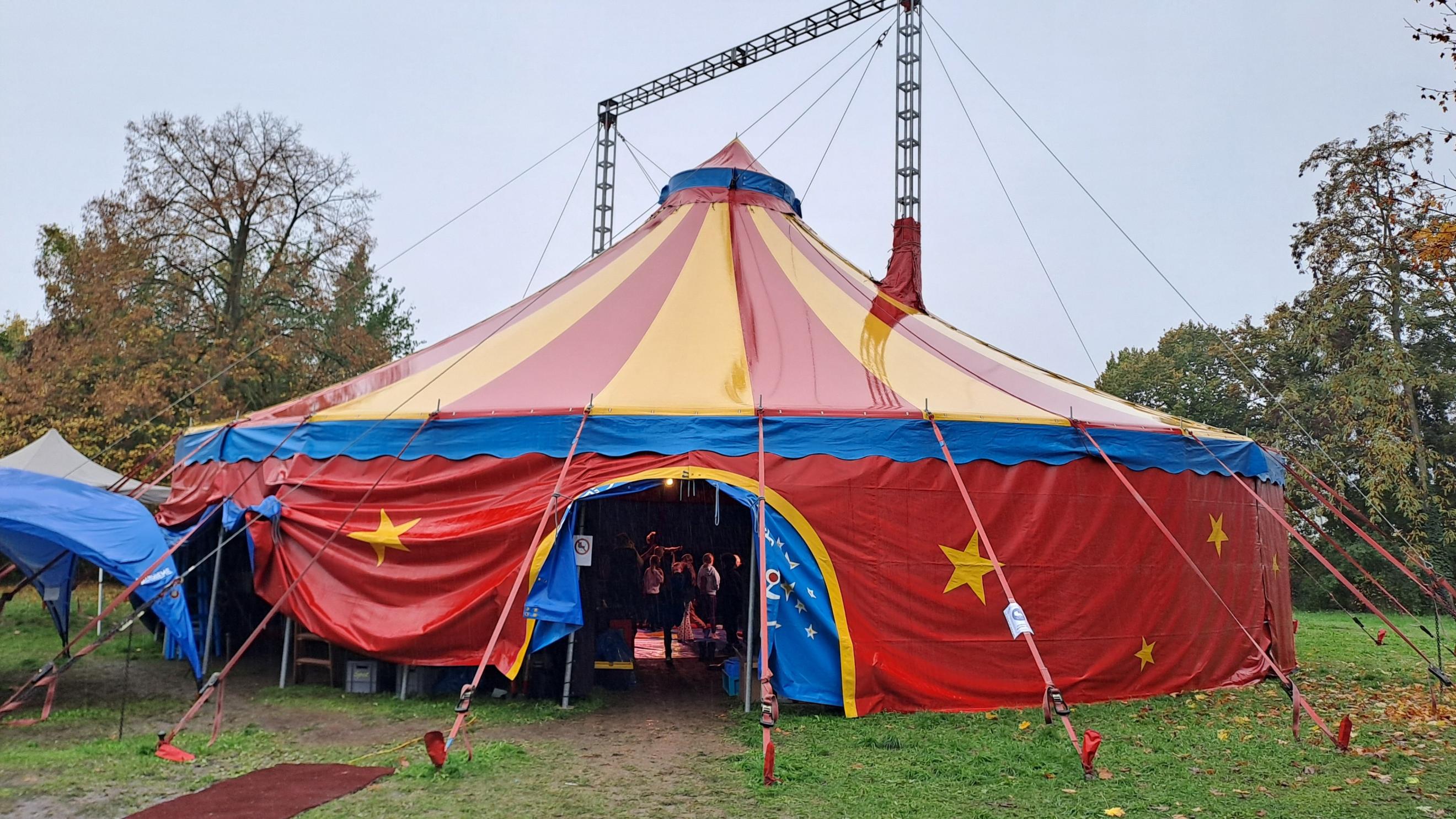 Ein Zirkuszelt steht auf einer Wiese